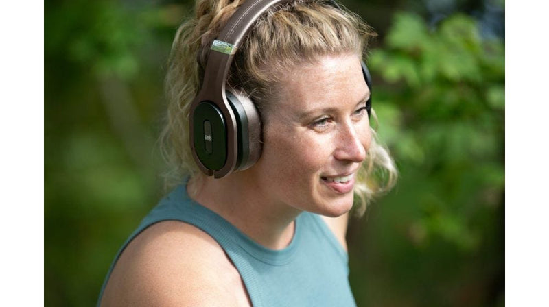 An athletic woman with PSB Espresso Brown M4U 8 MKII headphone